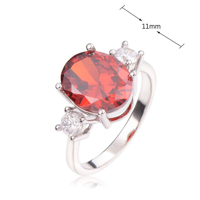 J&T STG Oval 9*11mm Red CZ White Ring